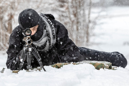 A young soldier trains with his weapon in a harsh snowstorm, braving icy winds and frozen terrain, his focus sharp and determined amid the rugged, wintry outdoor environment.の写真素材