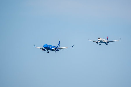 A commercial aircraft departs San Francisco International Airport on a bustling afternoon, carrying passengers toward destinations across the globe.のeditorial素材
