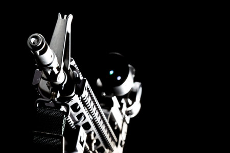 An AR-15 rifle is captured in sharp detail, photographed in a studio against a deep black background, its sleek lines and metallic finish highlighted by dramatic lighting.のeditorial素材