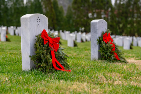 Atop a hill, a veterans cemetery with white headstones and the American flag evokes deep honor, sacrifice, and enduring national pride.の写真素材