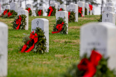 Atop a hill, a veterans cemetery with white headstones and the American flag evokes deep honor, sacrifice, and enduring national pride.の写真素材