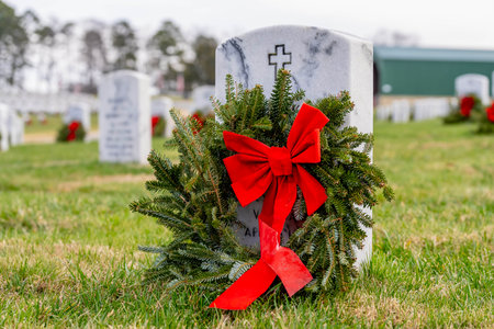 Atop a hill, a veterans cemetery with white headstones and the American flag evokes deep honor, sacrifice, and enduring national pride.の写真素材