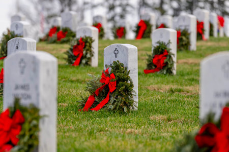 Atop a hill, a veterans cemetery with white headstones and the American flag evokes deep honor, sacrifice, and enduring national pride.の写真素材