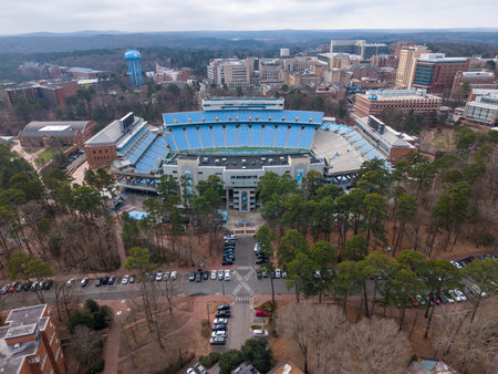 An aerial view of Kenan Stadium in Chapel Hill shows the historic UNC football venue nestled among trees, its classic bowl design anchoring campus since 1927 and home of the Tar Heels.のeditorial素材