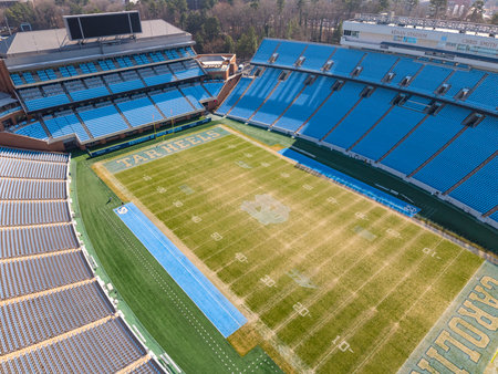 An aerial view of Kenan Stadium in Chapel Hill shows the historic UNC football venue nestled among trees, its classic bowl design anchoring campus since 1927 and home of the Tar Heels.のeditorial素材