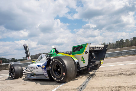 NTT INDYCAR SERIES driver, CAIO COLLET (R) (4) (BRA) of Sao Paulo, Brazil, comes down pit road...