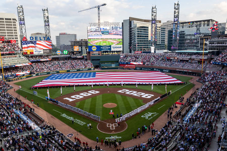 Opening Day in Atlanta dazzles as an American flag spans the field, fans rise cheering with pride...