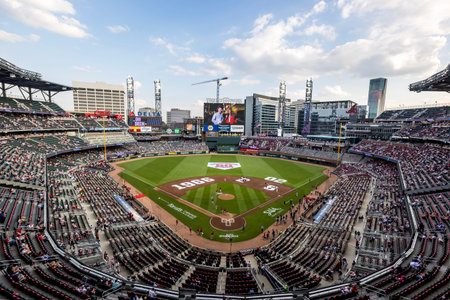 Opening Day energy fills Truist Park as fans in Braves gear cheer, wave flags, and soak in the excitement before the Royals vs Braves home opener begins in Atlanta, GA .のeditorial素材