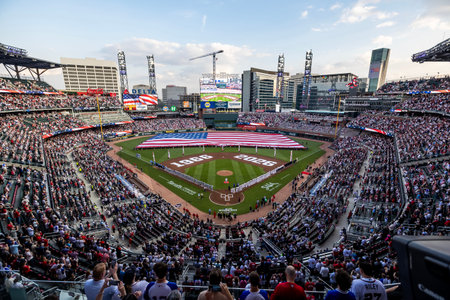 Opening Day in Atlanta dazzles as an American flag spans the field, fans rise cheering with pride...