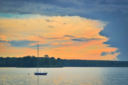 Boat on a beautiful lake. Evening summer landscape by the water.の写真素材