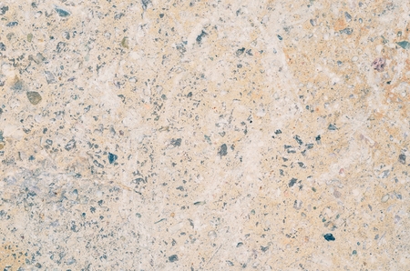 Bright stone background. Texture of pebbles on the wall.の写真素材