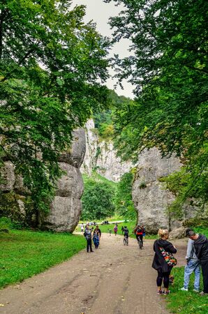 OJCOW, POLAND - AUGUST 13, 2017: Tourists at the Cracow Gate in the Ojcowski National Park, Poland.