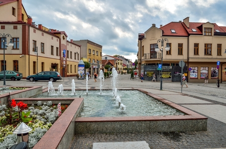 TRZEBINIA, POLAND - AUGUST 19, 2017: Colorful buildings and a nice fountain on the market in Trzebinia, Poland.のeditorial素材