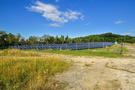 Renewable energy concept. Solar panels at the top of the mountain.