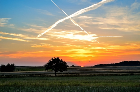Summer colorful landscape. Sunset over farmland in the countryside.の写真素材