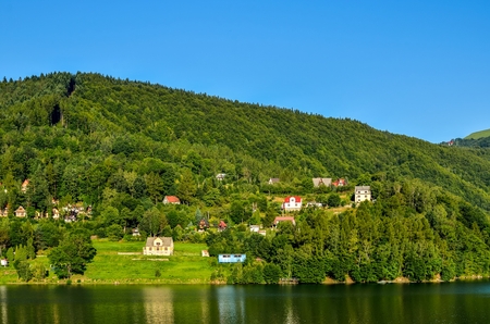 Summer mountain landscape. Beautiful mountain village by the lake.の写真素材
