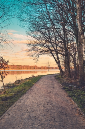 Beautiful urban landscape. Recreation path at the lake in the city.の写真素材