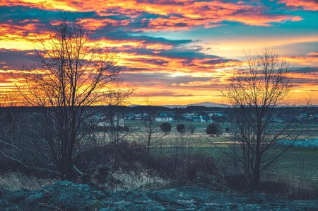 Beautiful morning landscape. Urban view on colorful sky and mountains.の写真素材