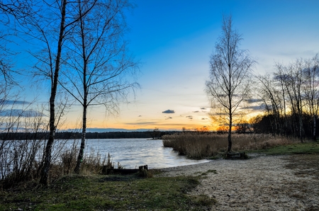 Beautiful morning landscape. Trees on the banks of the lake before sunrise.の写真素材