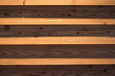 Wooden background from planks. Texture of boards illuminated by artificial light.の写真素材