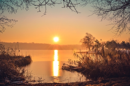 Beautiful winter landscape. Sunrise on the shore of the lake.の写真素材