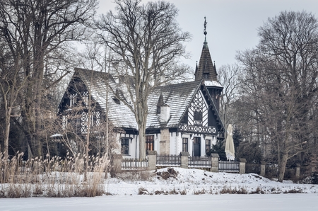 Beautiful historic castle in a winter scenery. Historic Hunting Palace in Promnice in Kobior, Poland.の写真素材