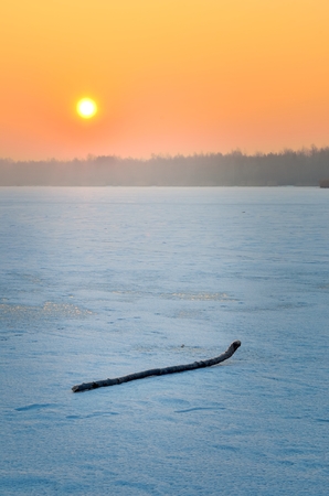 Beautiful winter sunrise. A frosty morning by the lake.の写真素材