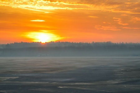 Beautiful winter sunrise. A frosty morning by the lake.の写真素材