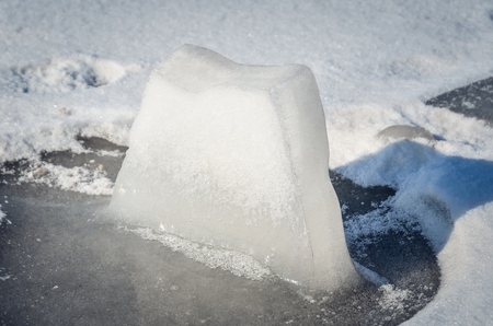 Winter white nature. A piece of ice on a frozen lake.の写真素材