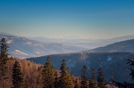 Beautiful winter mountain landscape. Sunny day on the trail in the Polish mountains.の写真素材