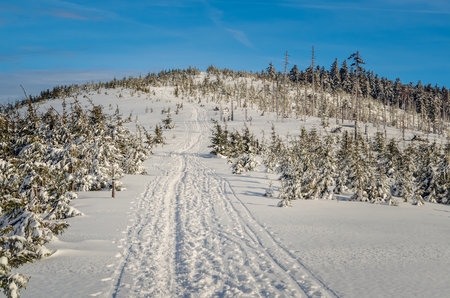 Beautiful winter mountain landscape. White snow trail in the mountains and blue sky.の写真素材