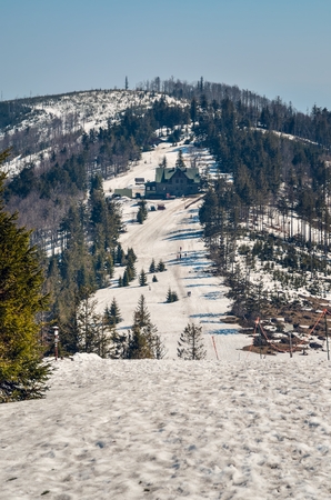 Beautiful winter springtime mountain landscape. Mountain slope with trees covered with white snow.の写真素材