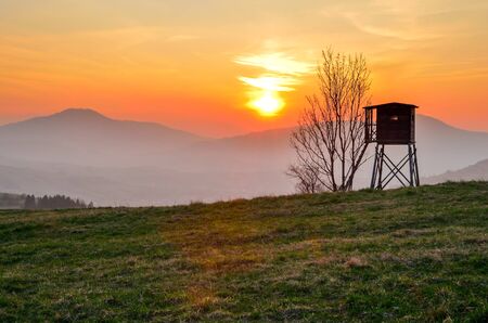 Beautiful mountain colorful landscape. Hunting pulpit and the setting sun over the hills.の写真素材