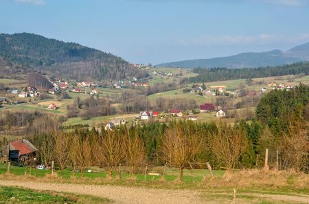 Beautiful spring mountain landscape. Houses in the countryside on the hill.の写真素材