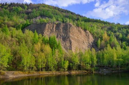 Beautiful spring mountain landscape. Quarry in the mountains by the lake.の写真素材