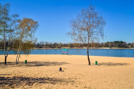 Beautiful spring landscape. Empty beach by the lake on a sunny day.の写真素材