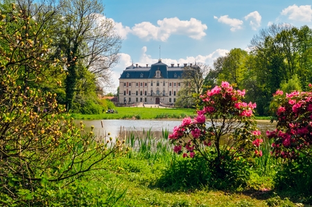 Beautiful historic castle in colorful spring scenery. Neo baroque castle in a park in Pszczyna in Poland.のeditorial素材