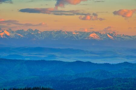 Beautiful mountain landscape. Snow-capped peaks in the light of the setting sun.の写真素材