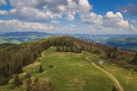 Beautiful mountain spring landscape. Picturesque path on the green hills.の写真素材