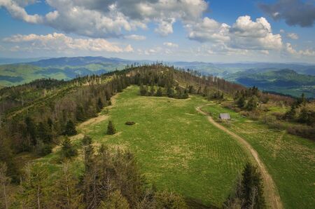 Beautiful mountain spring landscape. Picturesque path on the green hills.の写真素材