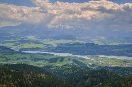 Beautiful mountain spring landscape. View of the Czorsztyn Lake and green valleys and hills.の写真素材