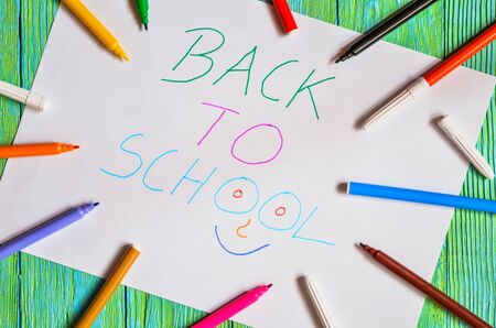 Creative idea depicting the return of children to school. School markers and a card with the text back to school.の写真素材