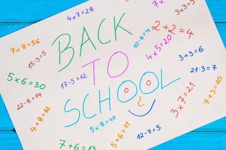 Creative idea depicting the return of children to school. White paper with mathematical operations and text back to school.の写真素材