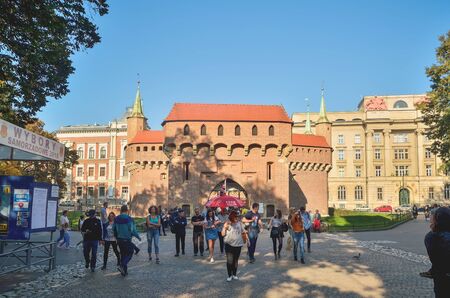 KRAKOW, POLAND - OCTOBER 13, 2018: Tourists under the historic Barbican building in Krakow, Poland.のeditorial素材
