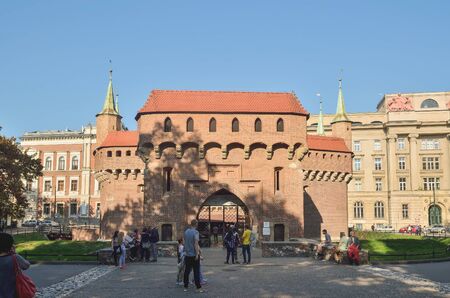 KRAKOW, POLAND - OCTOBER 13, 2018: Tourists under the historic Barbican building in Krakow, Poland.のeditorial素材
