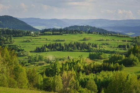 Beautiful mountain spring landscape. Picturesque valley and green hills.の写真素材