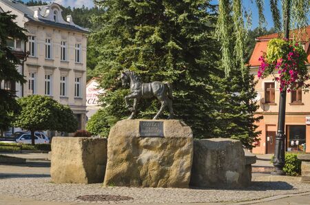 SUCHA BESKIDZKA, POLAND - SEPTEMBER 1, 2019: Monument to the horse and fountain at the market square in Sucha Beskidzka, Poland.のeditorial素材