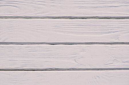 Wooden background texture. Creatively painted intense white boards.