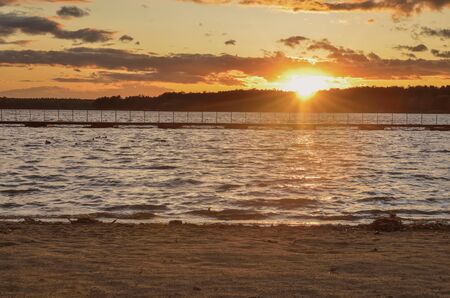 Beautiful colorful landscape. Sunset with a beautiful sky by the lake.の写真素材