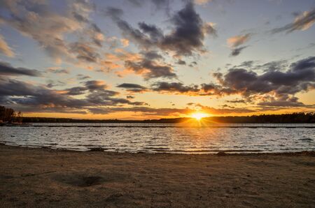 Beautiful colorful landscape. Sunset with a beautiful sky by the lake.の写真素材